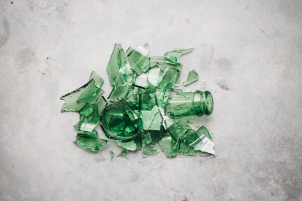 A pile of broken glass. It is green and appears to have been sourced from a smashed bottle.